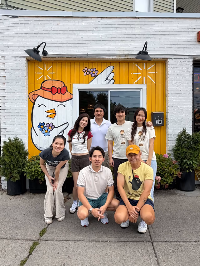 What Da Chick team together outside the restaurant mural